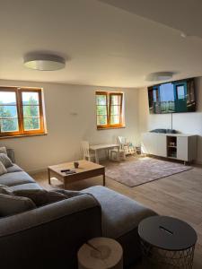 a living room with a couch and a table at Bouda Ticha in Dolní Malá Úpa
