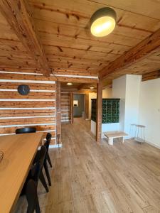 a room with wooden ceilings and a table and chairs at Bouda Ticha in Dolní Malá Úpa +24 photos