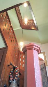 a wooden staircase with a chandelier in a room at Daheim Nr 2 - Südwesterhaus Allgäu in Oberstaufen