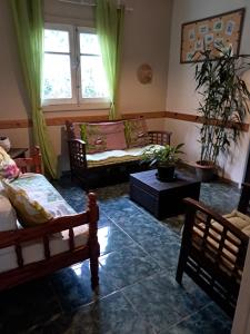 a living room with two beds and a couch at Chambre d'hôte Les Amoureux du Cirque in Cilaos