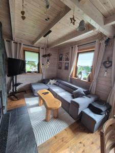 a living room with a couch and a table at GÓRSKA SIELANKA in Istebna