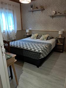 a bedroom with a bed with pillows on it at Chambre d'hôte Les Amoureux du Cirque in Cilaos