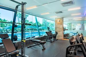 a gym with chairs and a swimming pool at Amathus Beach Hotel Limassol in Limassol