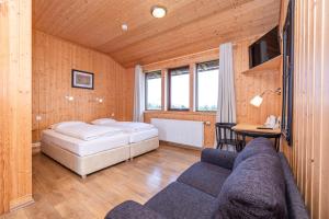 a bedroom with a bed and a couch in a room at Arnanes Country Hotel in Höfn