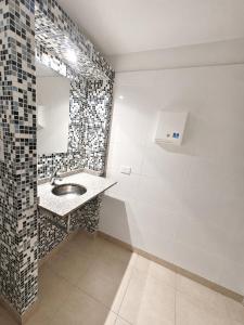 a bathroom with a sink and a mirror at Estudio Residencias in Buenos Aires +15 photos