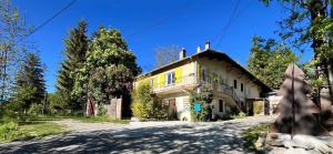 a yellow house on the side of a road at Les Gîtes de Chauvet in Gap