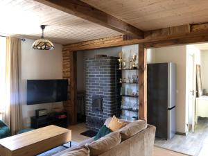 a living room with a couch and a fireplace at Rohu Külaliskorter vanalinnas in Kuressaare