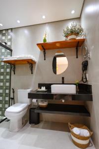 a bathroom with a sink and a toilet at Fruto Vermelho Pousada in Pedra Menina +32 photos