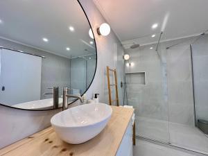 a bathroom with a large white bowl sink and a mirror at UpTown Apartments in Horta +14 photos
