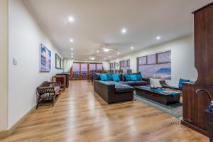 a living room with a couch and a table at Aquamarine Guest House in Mossel Bay