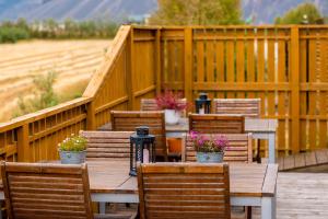 a wooden table and chairs with potted plants on it at Arnanes Country Hotel in Höfn +56 photos