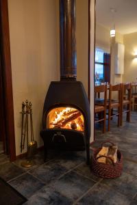 a wood stove in a room with a basket at Arnanes Country Hotel in Höfn