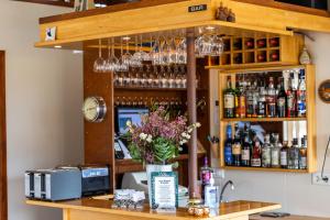 a bar with a vase of flowers on a counter at Arnanes Country Hotel in Höfn