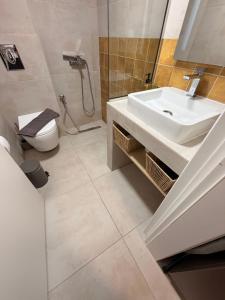 a bathroom with a sink and a toilet at Aurora Suite in Xanthi +9 photos