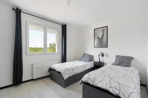a bedroom with two beds and a window at Villa Alfaro in Saint-Cernin-de-Larche +28 photos