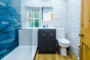 a bathroom with a toilet and a sink and a mirror at Fisherman's Cottage in Chester +24 photos
