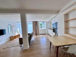 a living room with a table and a kitchen at UpTown Apartments in Horta