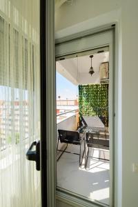 a sliding glass door to a balcony with a table at Smile Apartments in Bucharest