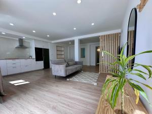 a living room with a couch and a kitchen at UpTown Apartments in Horta