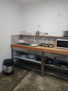 a kitchen with a wooden counter with a sink at Alojamiento Gofioplaya in Arinaga +8 photos