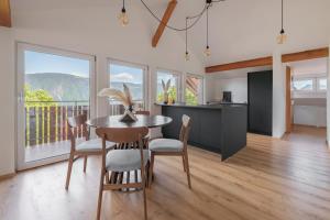a kitchen and dining room with a table and chairs at Mountain View Suites in Tisens