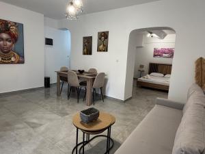 a living room with a couch and a table at SunWaves Apartments in Keramoti