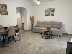 a living room with a couch and a table at SunWaves Apartments in Keramoti +21 photos