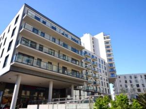 a large building in a city with tall buildings at New Central Woking 1 and 2 Bedroom Apartments with Free Gym, close to Train Station in Woking