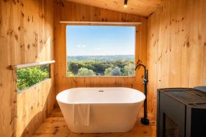 a bath tub in a room with a window at Kampaoh Alquézar in Alquézar