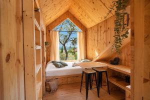 a room with a bed and a window at Kampaoh Alquézar in Alquézar