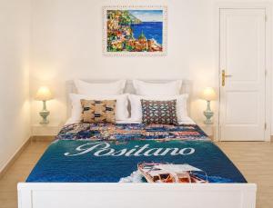 a bedroom with a bed with a blue comforter at Love in Blue - La Terrazza di Positano in Positano