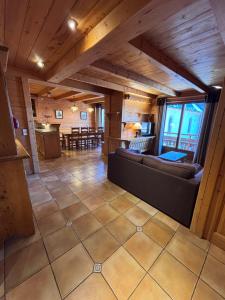 a large living room with a couch and a table at Appartement Chez Marion in Notre-Dame-de-Bellecombe