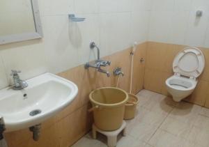 a bathroom with a sink and a toilet at Raya's Executive Homes in Kumbakonam +12 photos