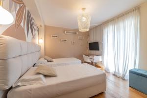 a hotel room with a bed and a desk at Villa Mastrissa Taormina - Private Villa with 2 pool in Taormina +56 photos