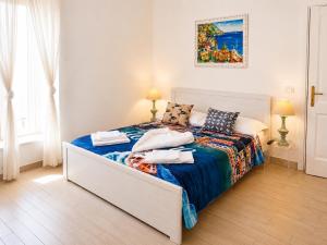 a bedroom with a bed with towels on it at Love in Blue - La Terrazza di Positano in Positano +48 photos