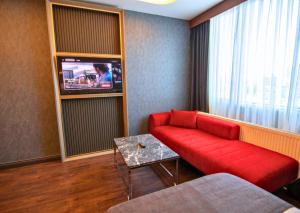 a living room with a red couch and a tv at 216 Eagle Palace Suite in Istanbul +18 photos