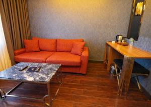 a living room with an orange couch and a table at 216 Eagle Palace Suite in Istanbul