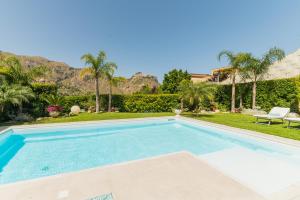 a swimming pool in the backyard of a house at Villa Mastrissa Taormina - Private Villa with 2 pool in Taormina