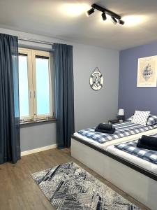 a bedroom with two beds and a window at Helski Zakątek in Hel