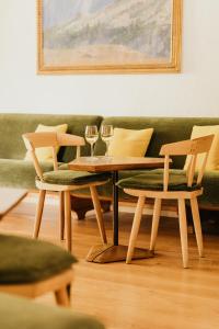 a table and two chairs with wine glasses on it at Hotel Corona in Cortina dʼAmpezzo