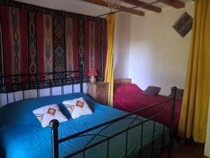 a bedroom with two beds with blue sheets at chambre à la campagne in Saint-Mathieu