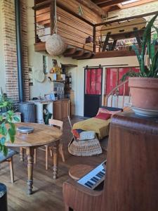 a room with a bed and a table with a piano at chambre à la campagne in Saint-Mathieu +1 photo