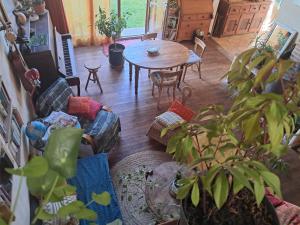 a living room with a table and a dining room at chambre à la campagne in Saint-Mathieu