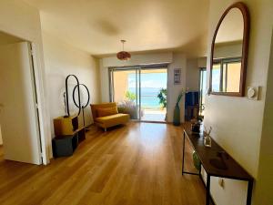 a living room with a view of the ocean at Casamea - Terrasse Mer, Plage 5min, Barbicaja in Ajaccio