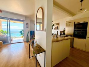 a large kitchen with a view of the ocean at Casamea - Terrasse Mer, Plage 5min, Barbicaja in Ajaccio