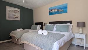 a bedroom with two beds with towels on them at The Bugle Inn in Bugle