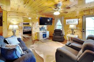 a living room with couches and a flat screen tv at Bluff Mountain Vista in Sevierville