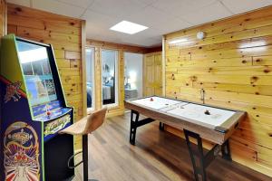 a game room with a table and a video game at Bluff Mountain Vista in Sevierville