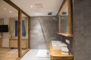 a bathroom with a sink and a shower at Gipfelhaus Gerlitzen in Arriach