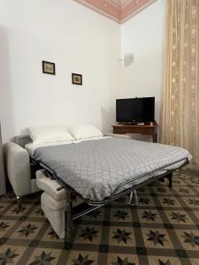a hospital bed in a room with a television at Crispi Accomodation B&B in Catania